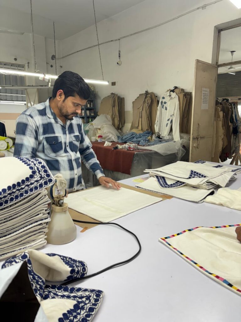 Finished embroidered pieces pressed and prepared for delivery