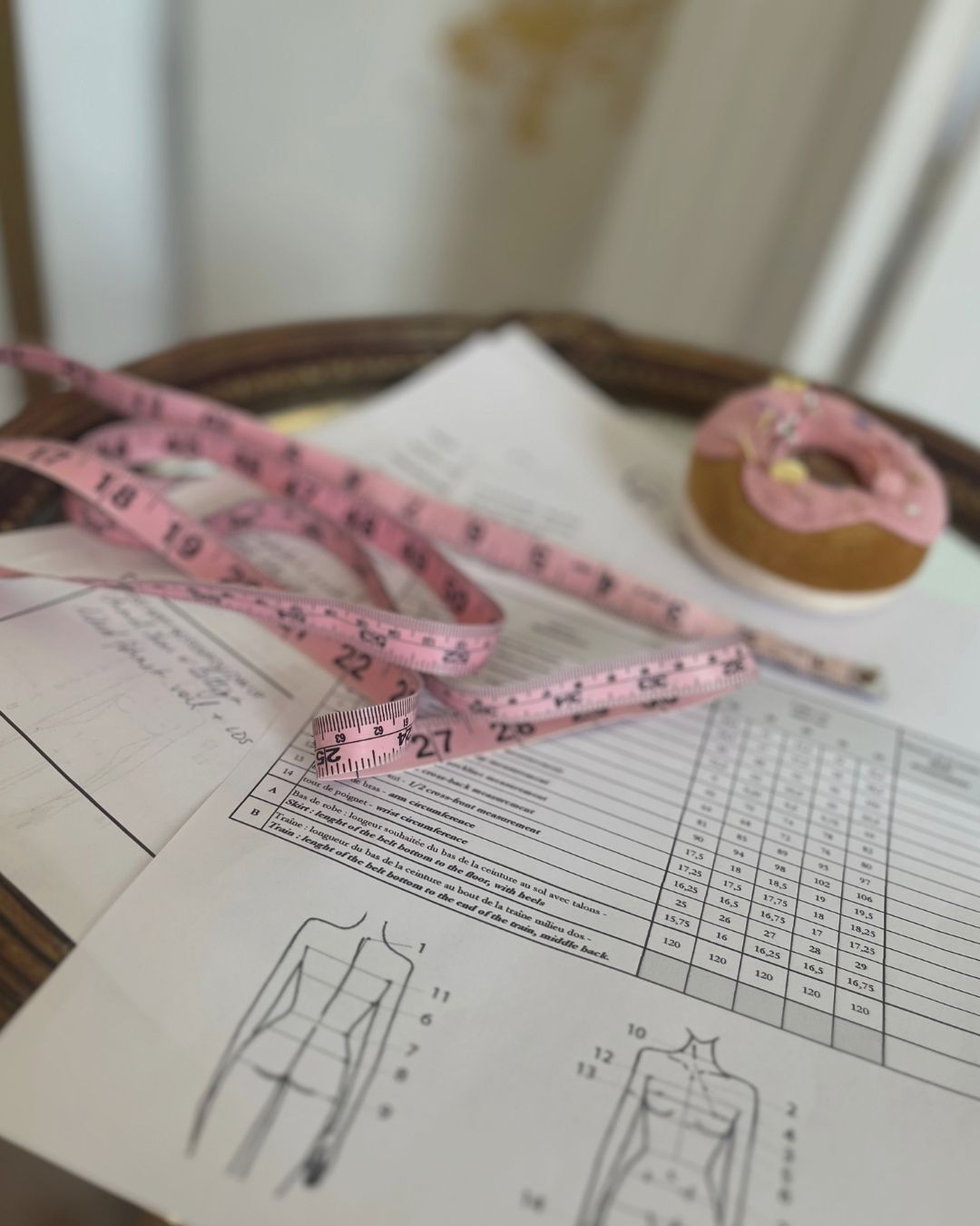 Design sketches and a tape measure on the studio table